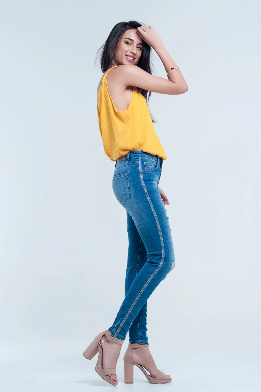 Skinny jeans with rips and glitter