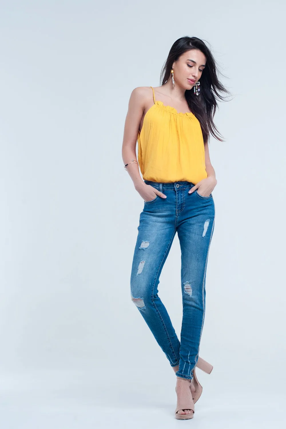 Skinny jeans with rips and glitter